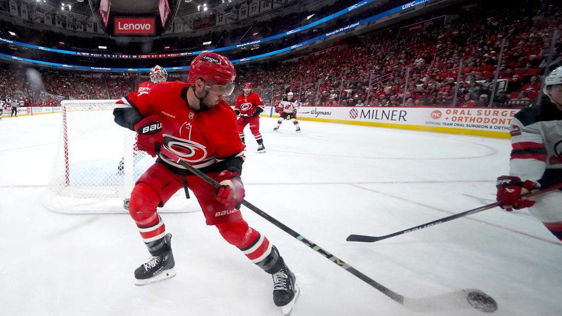 Oct 15, 2024; Raleigh, North Carolina, USA; Carolina Hurricanes defenseman Shayne Gostisbehere (4) played the puck against the New Jersey Devils during the second period at Lenovo Center.