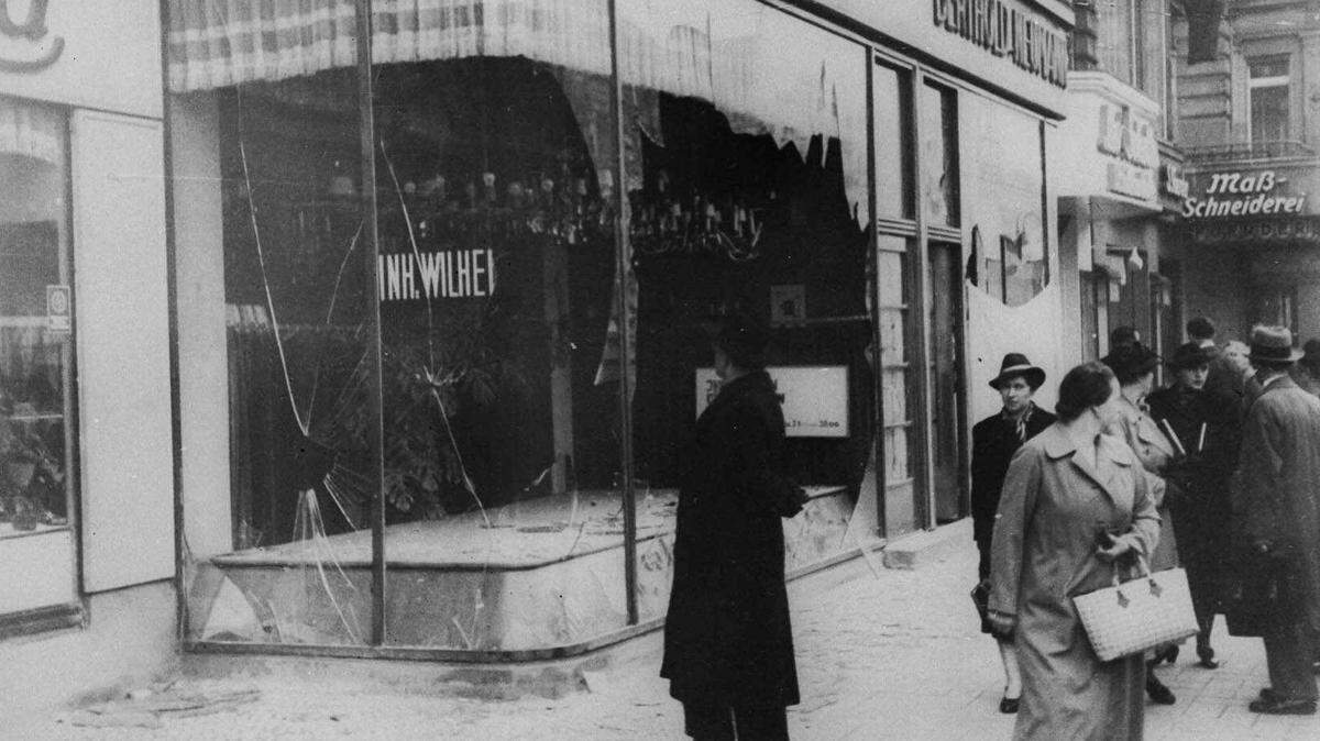 A man looks at damage to a Jewish shop in Berlin on Nov. 10, 1938, following Kristallnacht, an organized nationwide attack carried out over two days by Nazi forces and German civilians. Perpetrators set fire to hundreds of synagogues, looted thousands of Jewish businesses and attacked Jews throughout Germany. For many, it marks the beginning of the Holocaust.