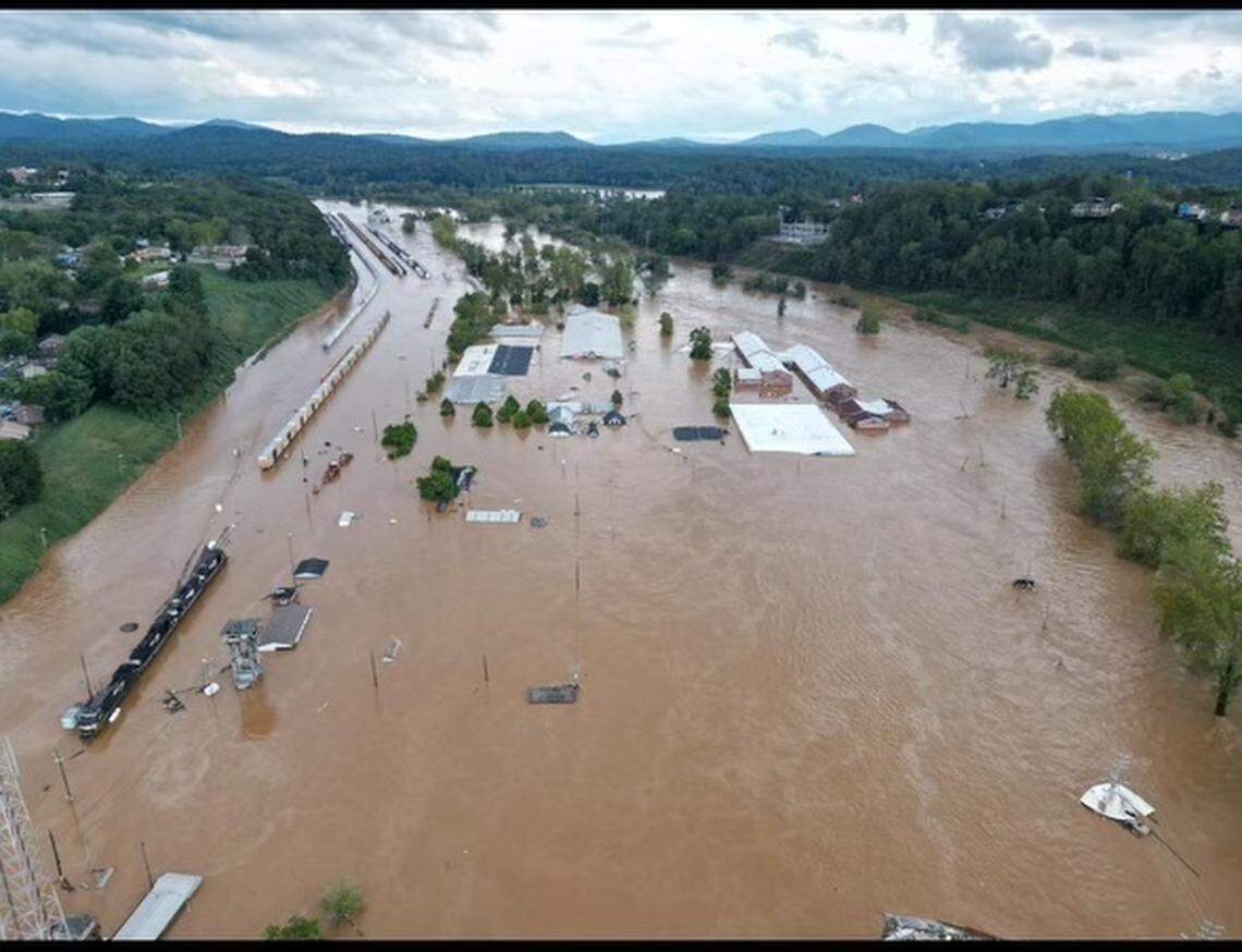Norfolk Southern railway’s freight yard in Asheville was flooded by the French Broad River after the remnants of Hurricane Helene hit Western North Carolina. The Asheville River Arts District, center, lies between the river and the rail yard.