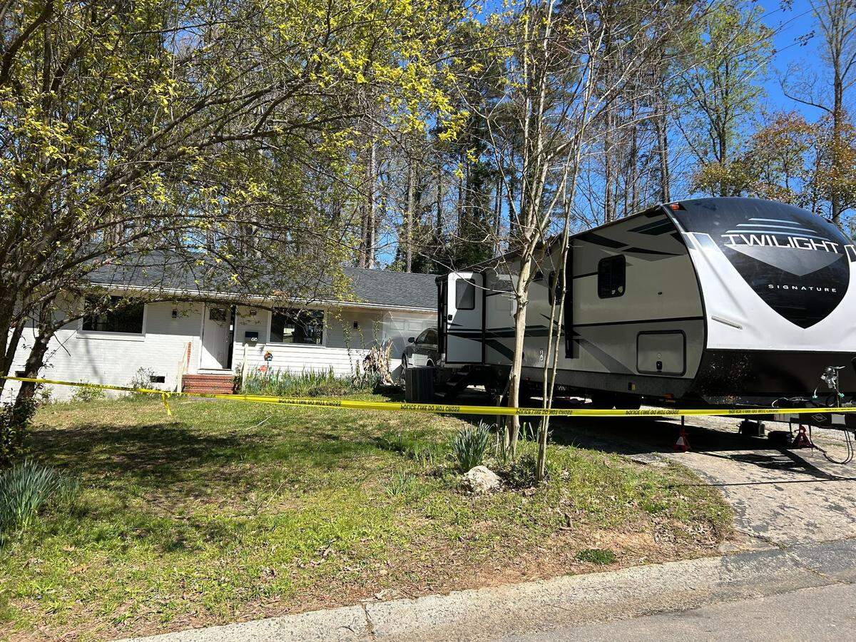 An RV is parked in front of a Cary house where human remains were found burning in a fire pit on March 19, 2023.