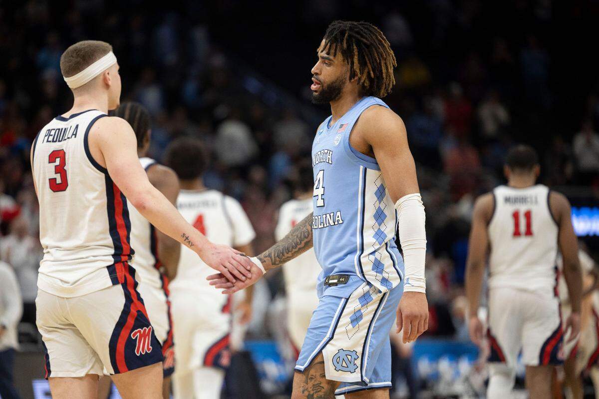 North Carolina guard R.J. Davis (4) congratulates Ole Miss guard Sean Pedulla (3) following their 71-64 victory in the first round of the NCAA Tournament t on Friday, March 21, 2025 at Fiserv Forum in Milwaukee, Wisconsin. Pedulla scored 20 points in the victory.