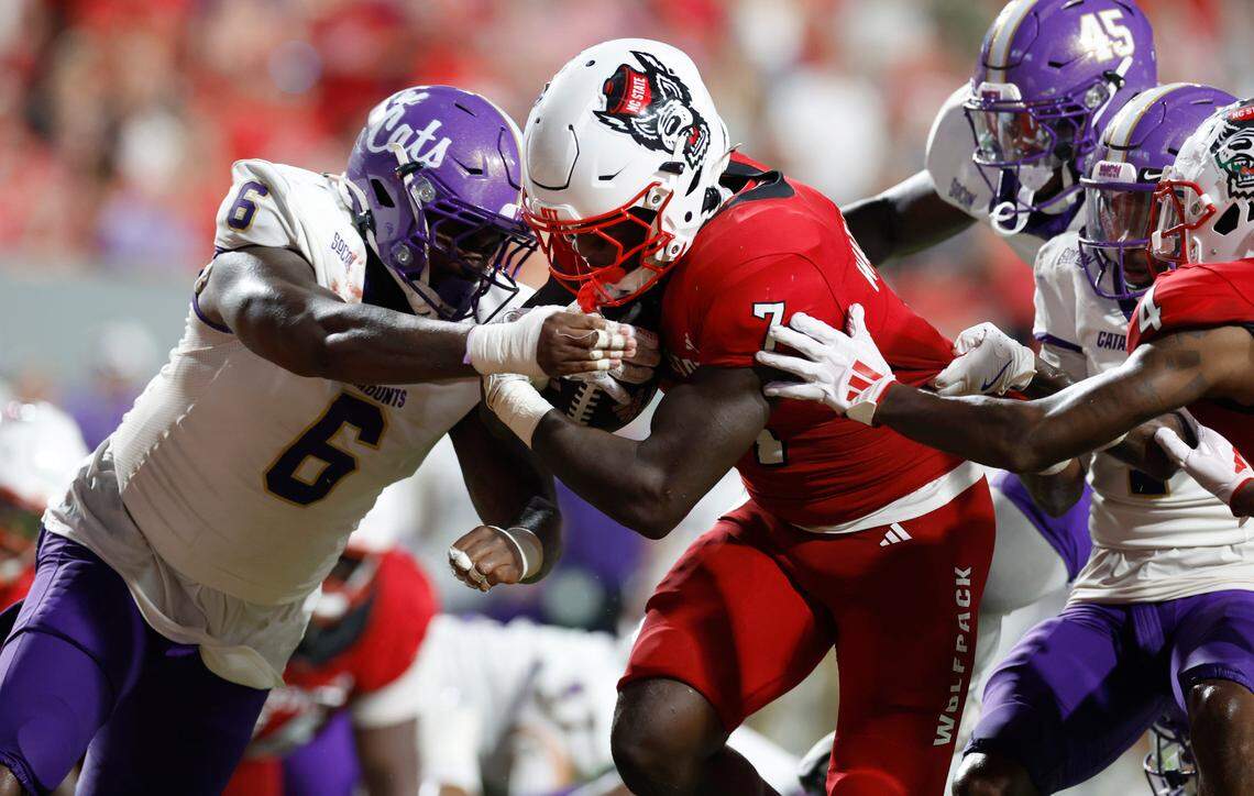 N.C. State running back Jordan Waters (7) barrels past Western Carolina defensive lineman Curtis Fann Jr. (6) to score on a seven-yard touchdown run during the second half of N.C. State’s 38-21 victory over Western Carolina at Carter-Finley Stadium in Raleigh, N.C., Thursday, August 29, 2024.