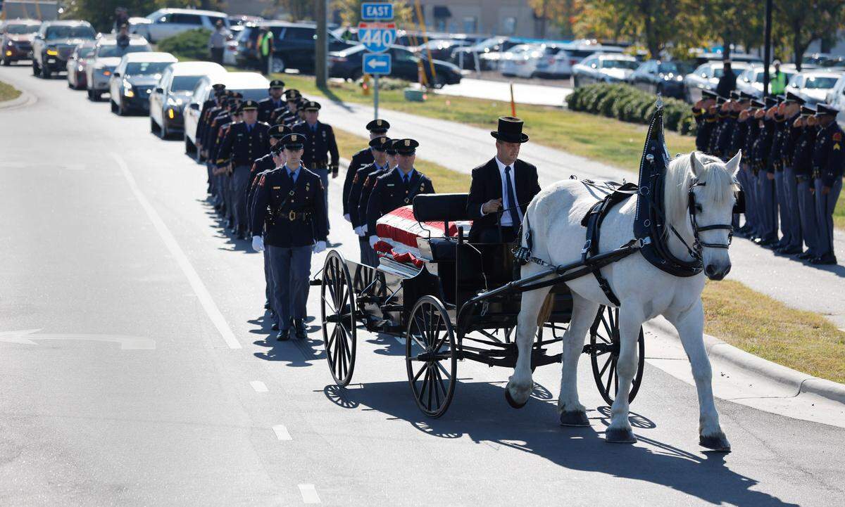 A funeral caisson transports the casket of Raleigh Police Officer Gabriel Torres down Yonkers Road to Cross Assembly Church in Raleigh, N.C. for his funeral Saturday, Oct. 22, 2022. Officer Torres was killed during a mass shooting Oct. 13.