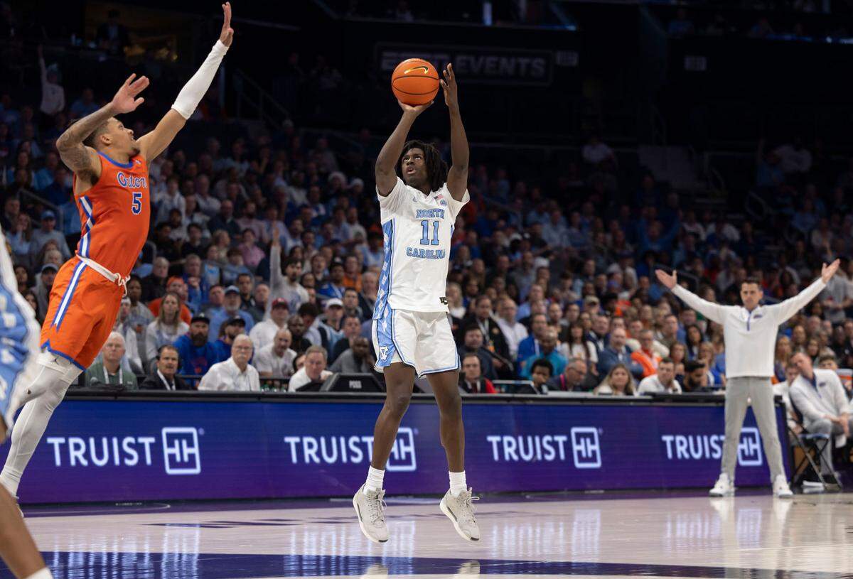 North Carolina guard Ian Jackson (11) launches a three-point attempt against Florida’s Will Richard (5) in the second half during the Jumpman Invitational on Tuesday, December 17, 2024 at the Spectrum Center in Charlotte, N.C.