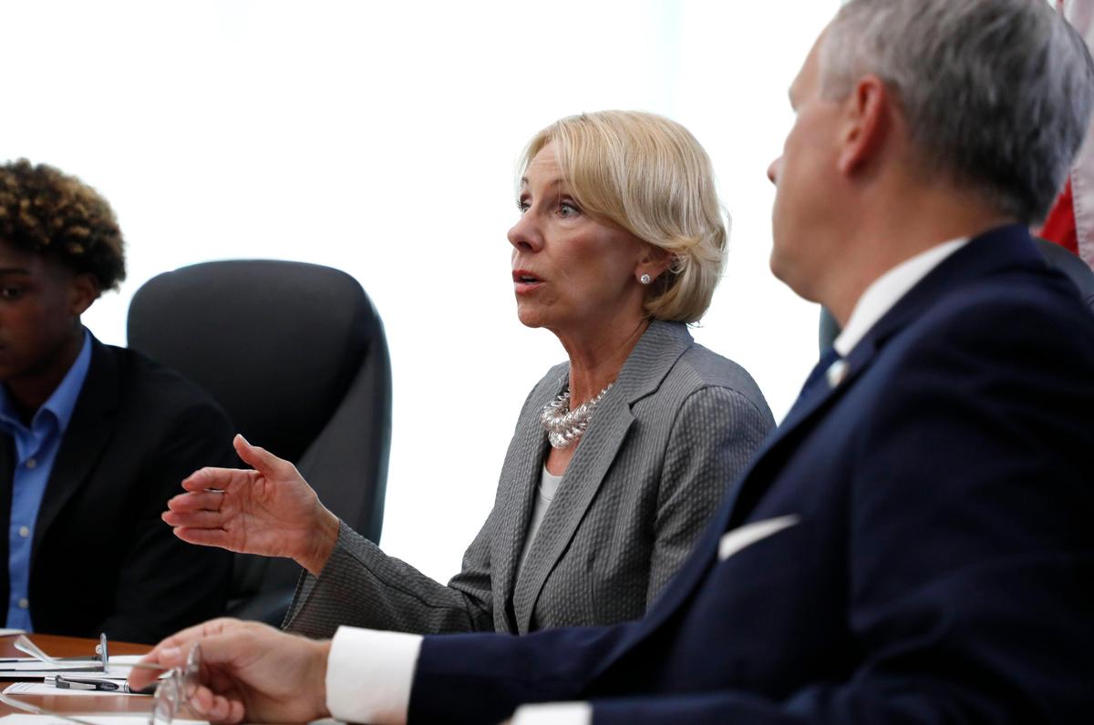U.S. Education Secretary Betsy DeVos, left, leads a discussion about Education Freedom Scholarships, a new federal school choice program, during a roundtable at the N.C. Museum of Natural Science in Raleigh, N.C., Wednesday, July 17, 2019. Lt. Gov. Dan Forest is to the right.