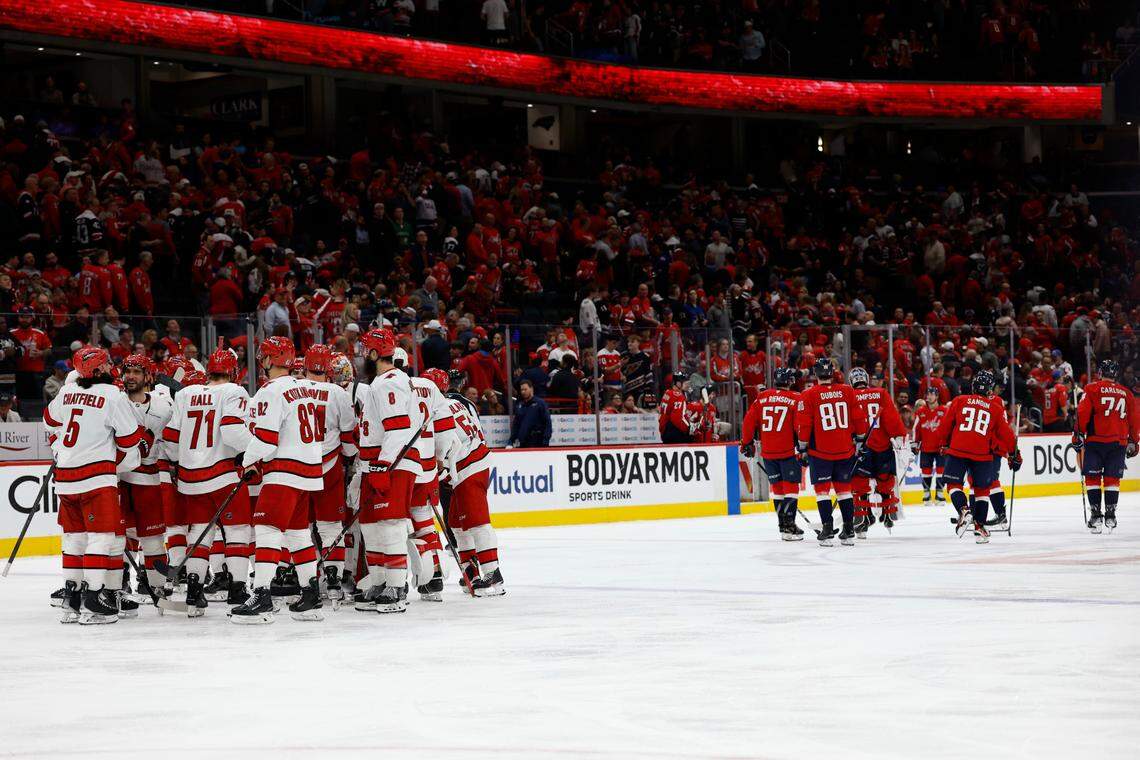 May 6, 2025; Washington, District of Columbia, USA; Carolina Hurricanes defenseman Jaccob Slavin (74) celebrates with teammates after scoring the game winning goal against the Washington Capitals/in overtimein game one of the second round of the 2025 Stanley Cup Playoffs at Capital One Arena. Mandatory Credit: Geoff Burke-Imagn Images
