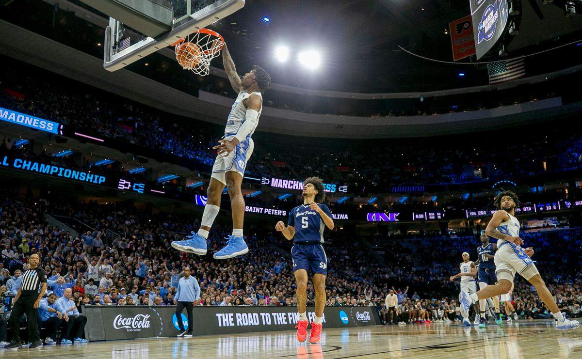 North Carolina’s Caleb Love (2) breaks to the basket for a dunk on a fast break ahead Saint Peter’s Daryl Banks III (5) in the second half during of the NCAA East Regional final on Sunday, March 27, 2022 at Wells Fargo Center in Philadelphia, Pa.