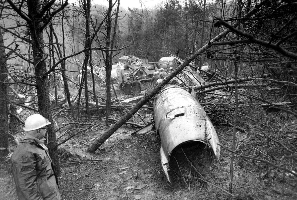 In this Nov. 15, 1970, file photo, a fireman looks over the wreckage of a DC-9 jet in Kenova, W.Va, that was carrying the Marshall University football team.