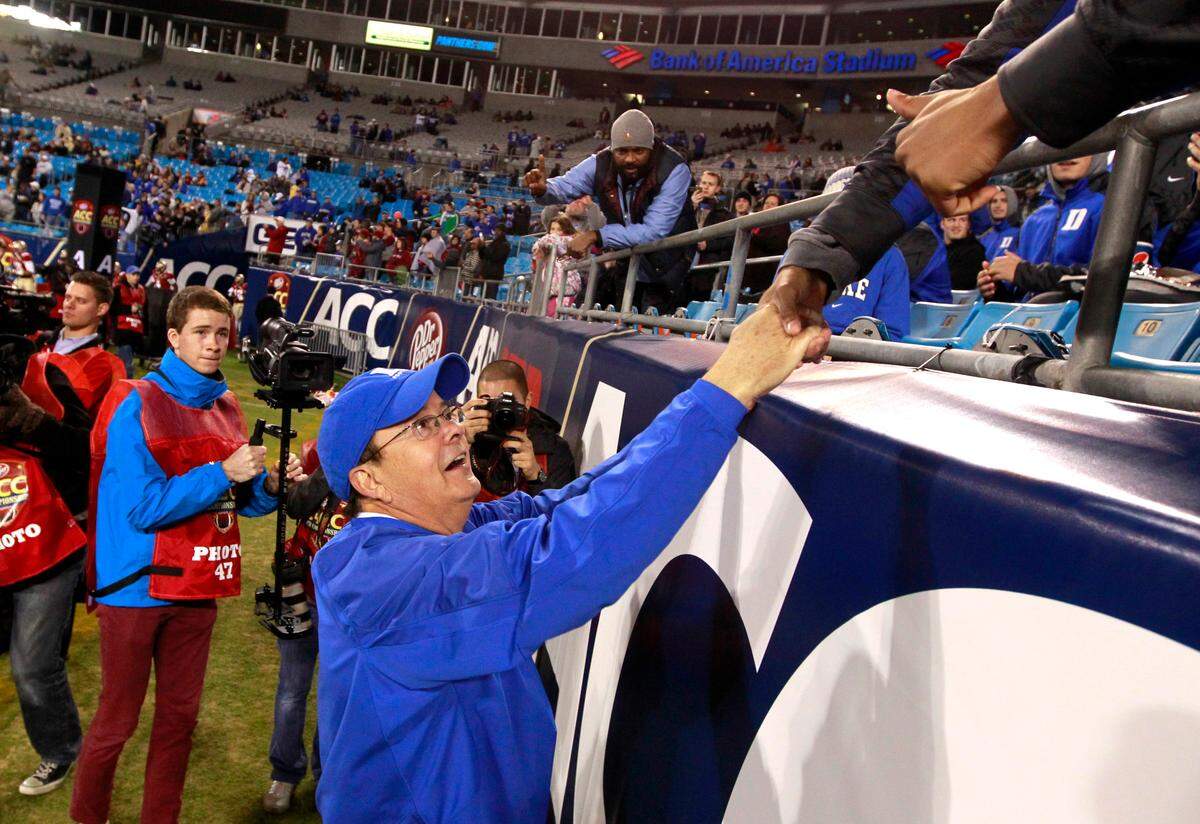 Duke’s David Cutcliffe greets fans before Duke’s game against Florida State in the ACC Football Championship game at Bank of America Stadium in Charlotte in 2013.