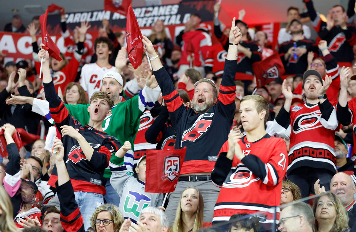 Hurricanes fans celebrate after a Columbus goal was disallowed after a review during the second period of the Carolina Hurricanes game against the Columbus Blue Jackets at PNC Arena in Raleigh, N.C., Wednesday, Oct. 12, 2022.