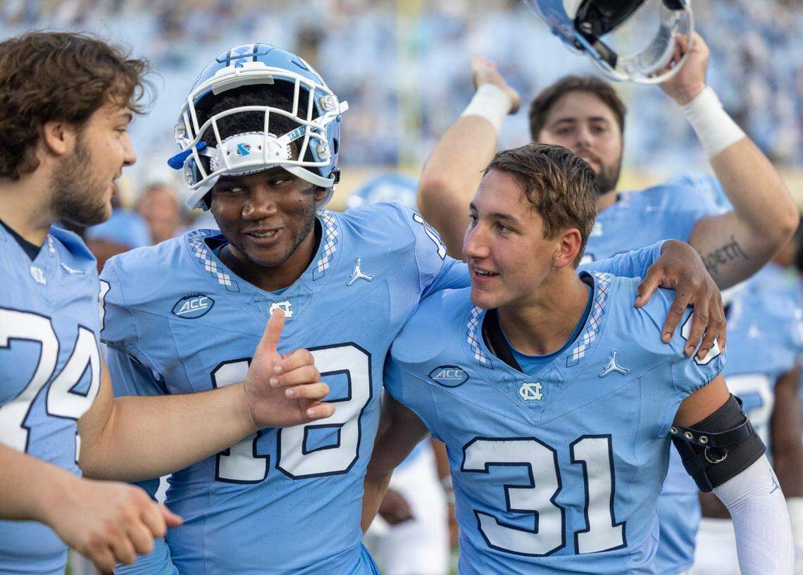 North Carolina’s Justin Kanyuk (74), Christopher Holliday (18) and Will Hardy (31) celebrate the Tar Heels’ 31-13 victory over Minnesota on Saturday, September 16, 2023 at Kenan Stadium in Chapel Hill N.C.