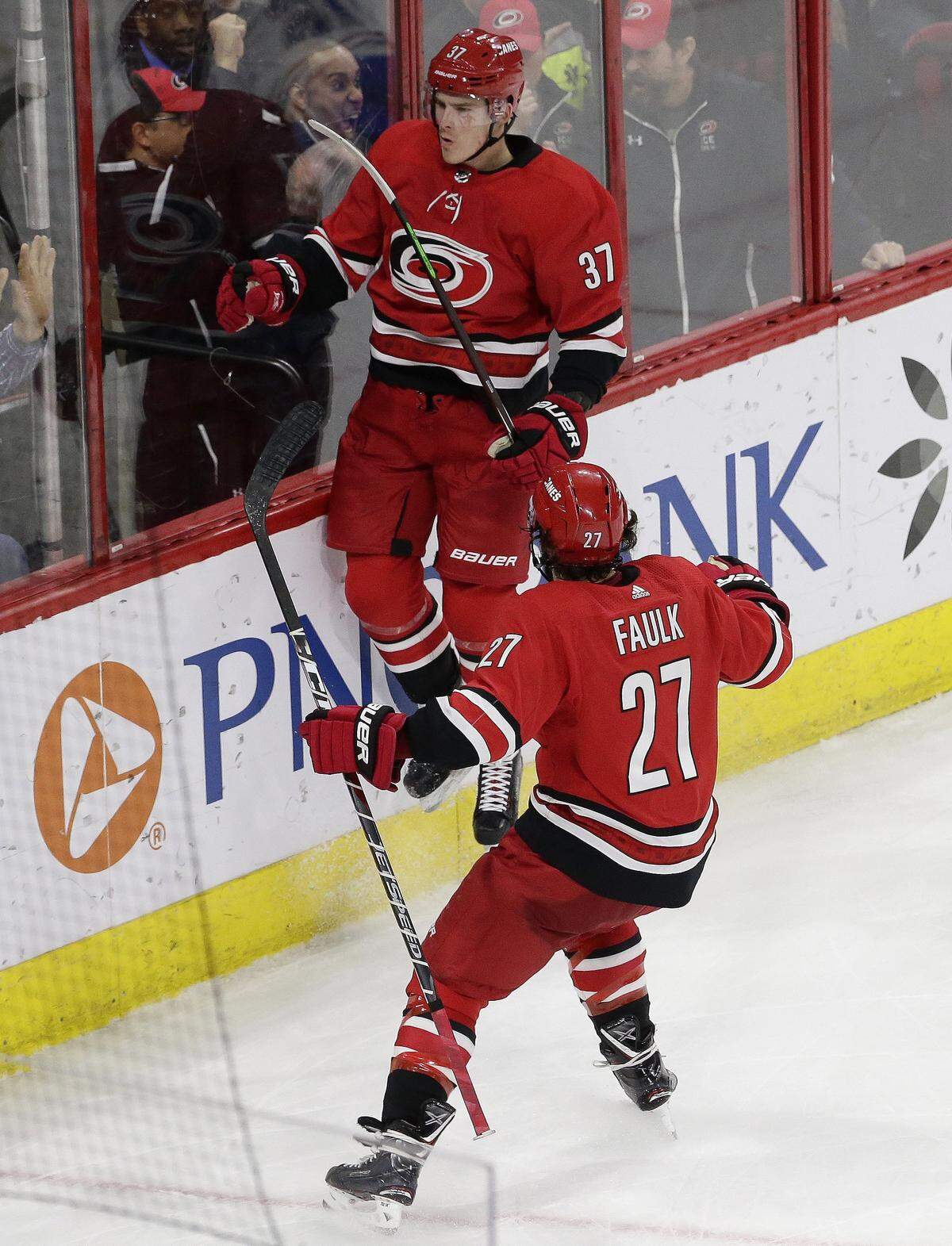 Carolina Hurricanes’ Andrei Svechnikov (37), of Russia, jumps onto the boards while celebrating his game winning goal against the Montreal Canadiens with Justin Faulk (27) during overtime in an NHL hockey game in Raleigh, N.C., Sunday, March 24, 2019. Carolina won 2-1.