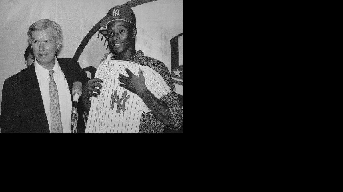 A 1991 AP file photo shows New York Yankee's vice president and general manager Gene Michael with number one draft pick Brien Taylor after the Yankees signed Taylor to a one-year 1.55 million dollar minor league contract.  Taylor, then 19, had just graduated from high school in NC two months earlier.