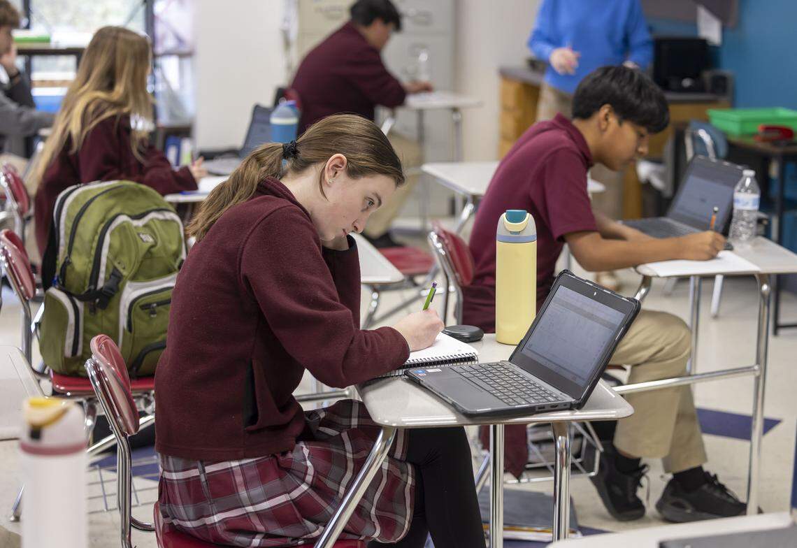 Jennifer O’Connell, an eighth grader St. Catherine of Siena Catholic School, works in her social studies and religion class.