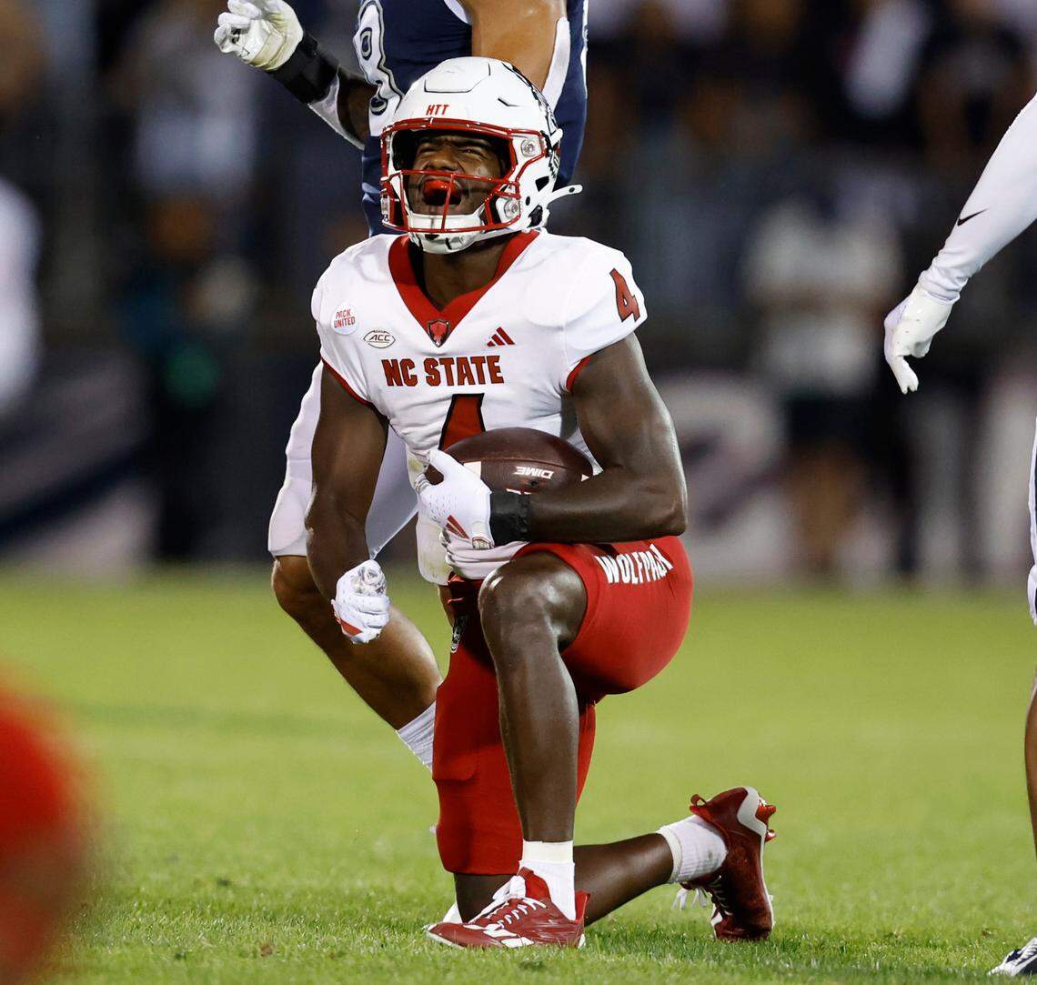 N.C. State wide receiver Porter Rooks (4) celebrates after making a reception for a first down during the first half of N.C. State’s game against UConn at Rentschler Field in East Hartford, Conn. Thursday, August 31, 2023.