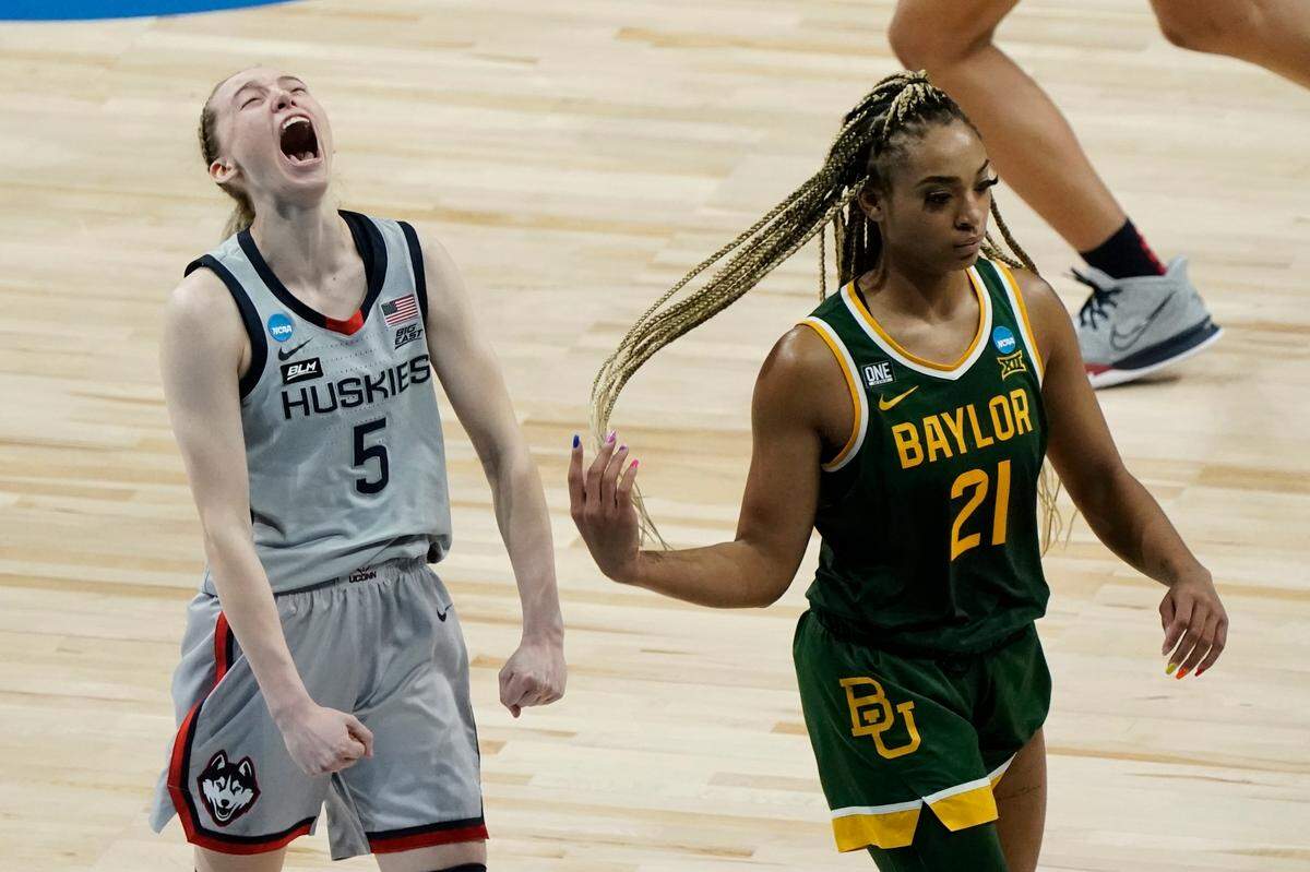 UConn’s Paige Bueckers celebrates in front of Baylor’s DiJonai Carrington after an NCAA college basketball game in the Elite Eight round of the Women’s NCAA tournament Monday, March 29, 2021, at the Alamodome in San Antonio. UConn won 69-67 to advance to the Final Four. 