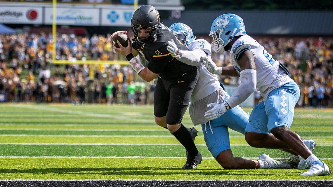 North Carolinaís Noah Taylor (7) and Caiman Rucker (25) stop Appalachian State quarterback Chase Brice at the goal line with :09 second to play, preventing a two-point conversion and securing North Carolinaís 63-61 victory on Saturday, September 3, 2022 at Kidd Brewer Stadium in Boone, N.C.