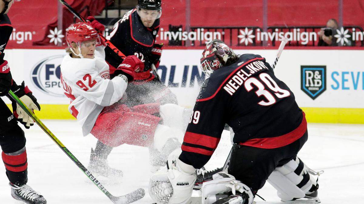 Carolina Hurricanes’ Brett Pesce (22) and Alex Nedeljkovic (39) defend against Detroit Red Wings’ Vladislav Namestnikov (92) during the third period of an NHL hockey game in Raleigh, N.C., Thursday, March 4, 2021. AP Photo/Chris Seward)