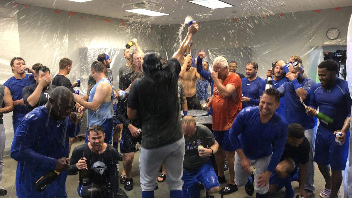 Durham Bulls players and coaches celebrate an International League playoff series win over the Scranton/Wilkes-Barre RailRiders in their clubhouse on Saturday, Sept. 7, 2019, in Moosic, Pa. The Bulls are seeking their third consecutive league championship.