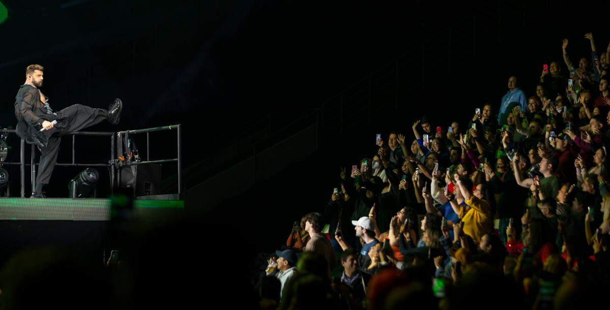 Ricky Martin works the crowd from a riser on “The Trilogy Tour” at Raleigh, N.C.’s PNC Arena, Thursday night, Feb. 29, 2024.