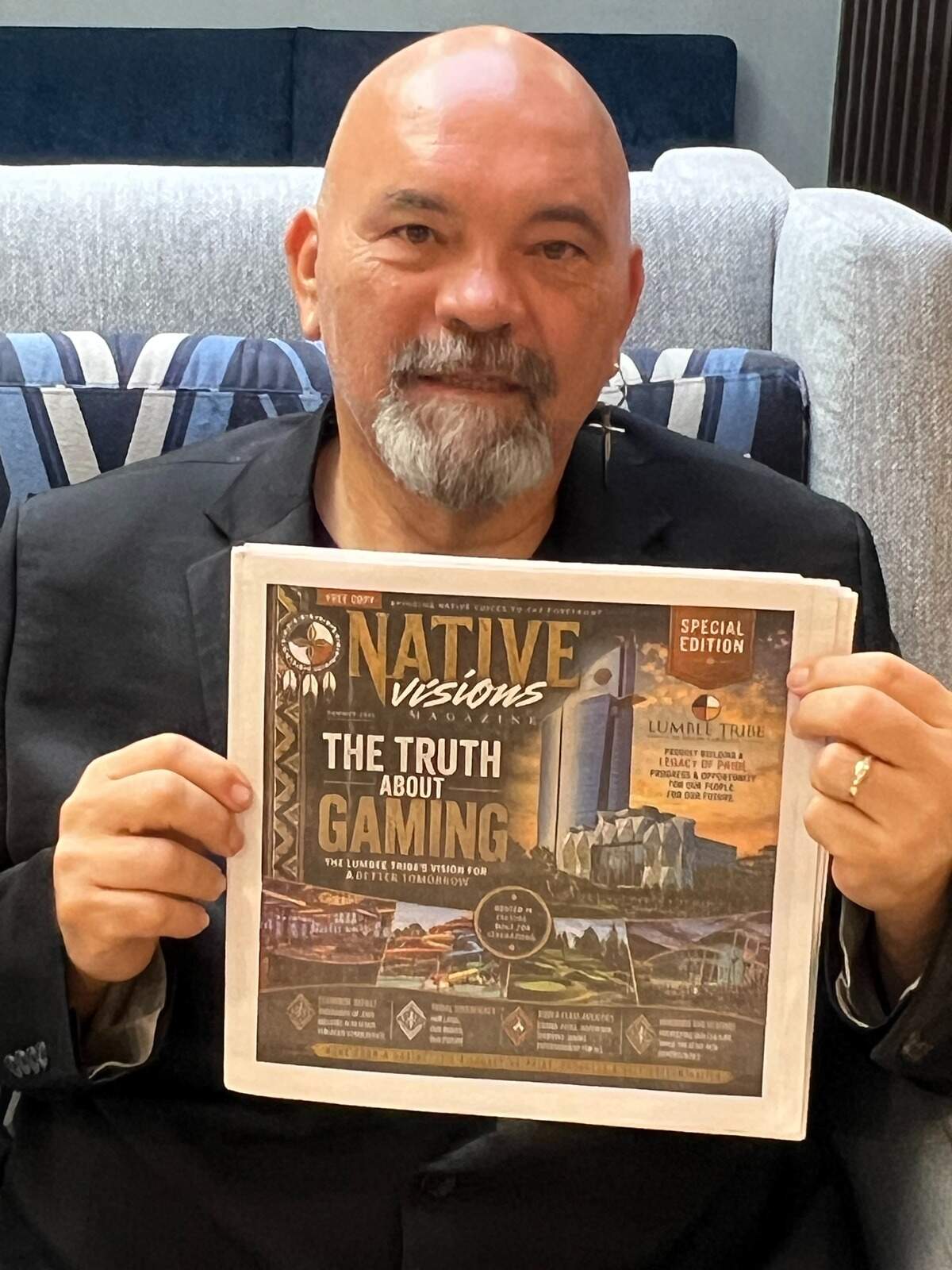 Publisher James Locklear holds a copy of his Native Visions which aimed to explain all the implications involved in gaming.