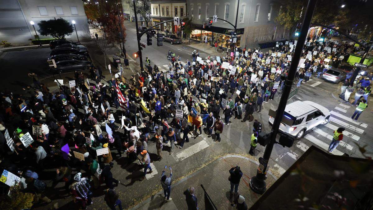 Hundreds march in downtown Raleigh Tuesday night, Nov 18, 2025, to protest Border Patrol agents making raids and arrests in the Triangle. 