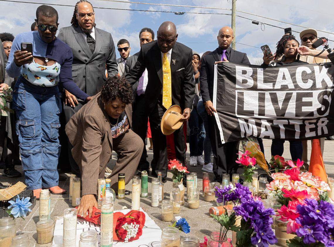 Sonya Williams lays flowers at a memorial on Rock Quarry Road near where her son, Darryl Williams, died after being tased by the Raleigh Police Department on Thursday, Feb. 16, 2023 in Raleigh, N.C.