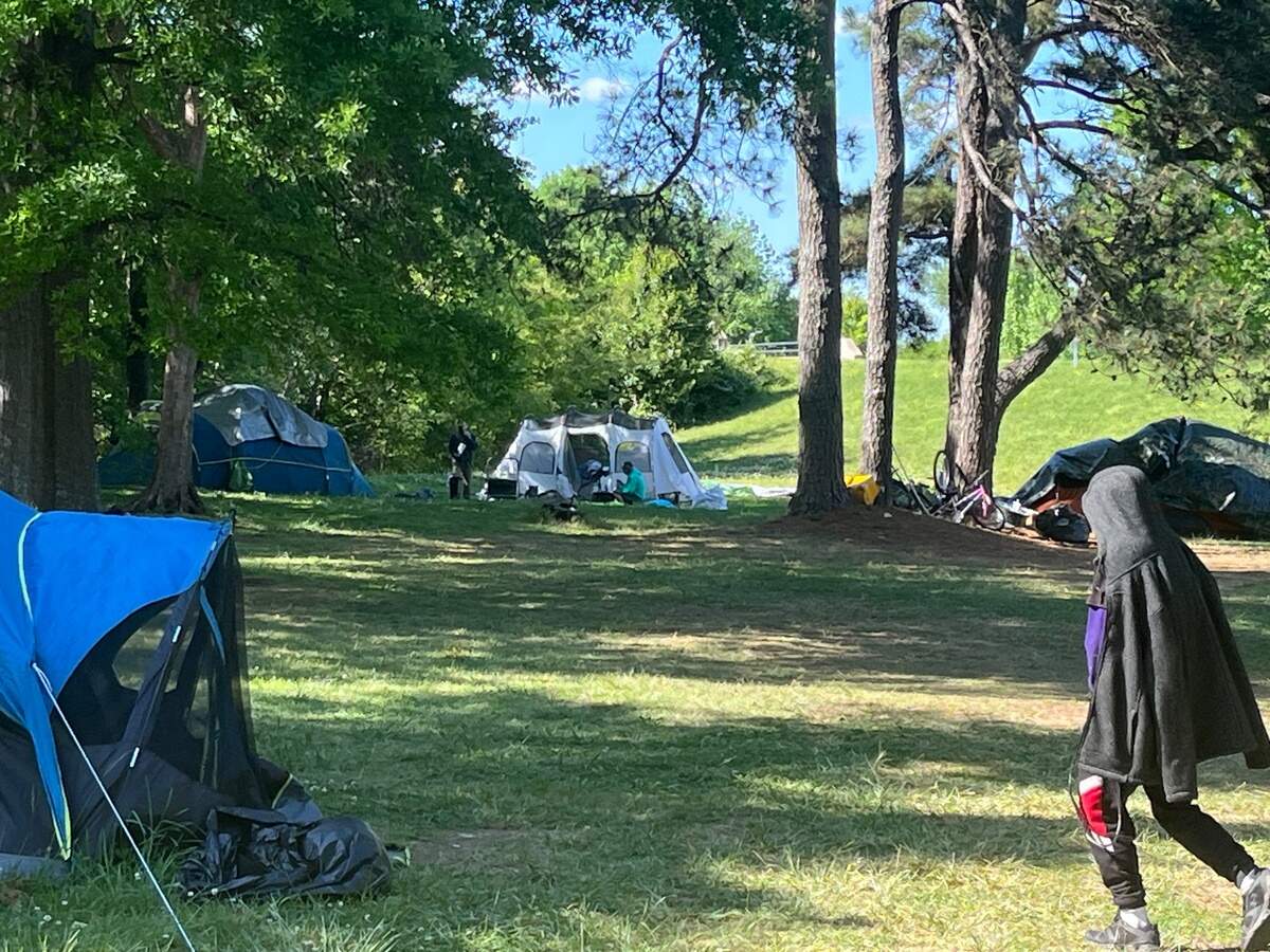 Many people experiencing homelessness live in makeshift camps hidden in the trees along major roads and near shopping centers in Orange County, NC. Others bed down in the doorways of Franklin Street businesses at night.