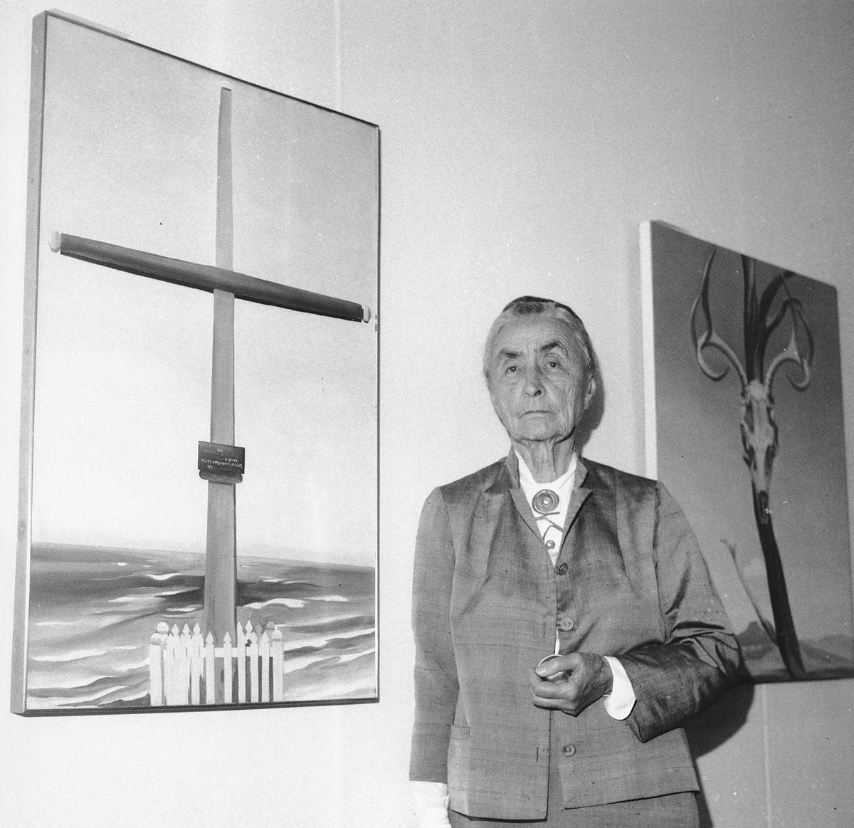 Georgia O’Keeffe stands next to her original oil paintings during a press review on Oct. 8, 1970, of her 121 paintings, watercolors, and drawings on exhibit at the Whitney Museum of American Art in New York.  O’Keeffe’s work comes to the North Carolina Museum of Art in the exhibit, “The Beyond: Georgia O’Keeffe and Contemporary Art.”