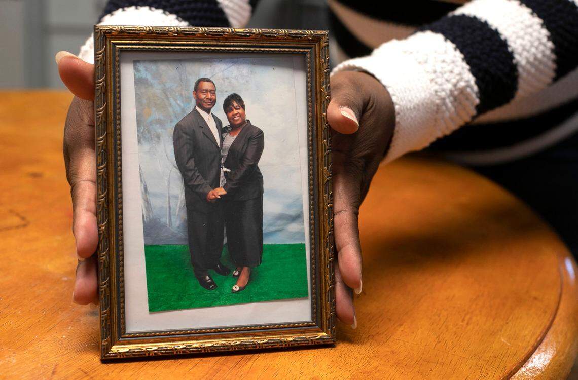 Kendra Ward holds a photograph of her late mother Annie Pearl Wiggins and her dad James Wiggins in Rocky Mount, N.C. on Wednesday, December 2, 2020. Annie Pearl Wiggins died of the COVID-19 virus in late October.