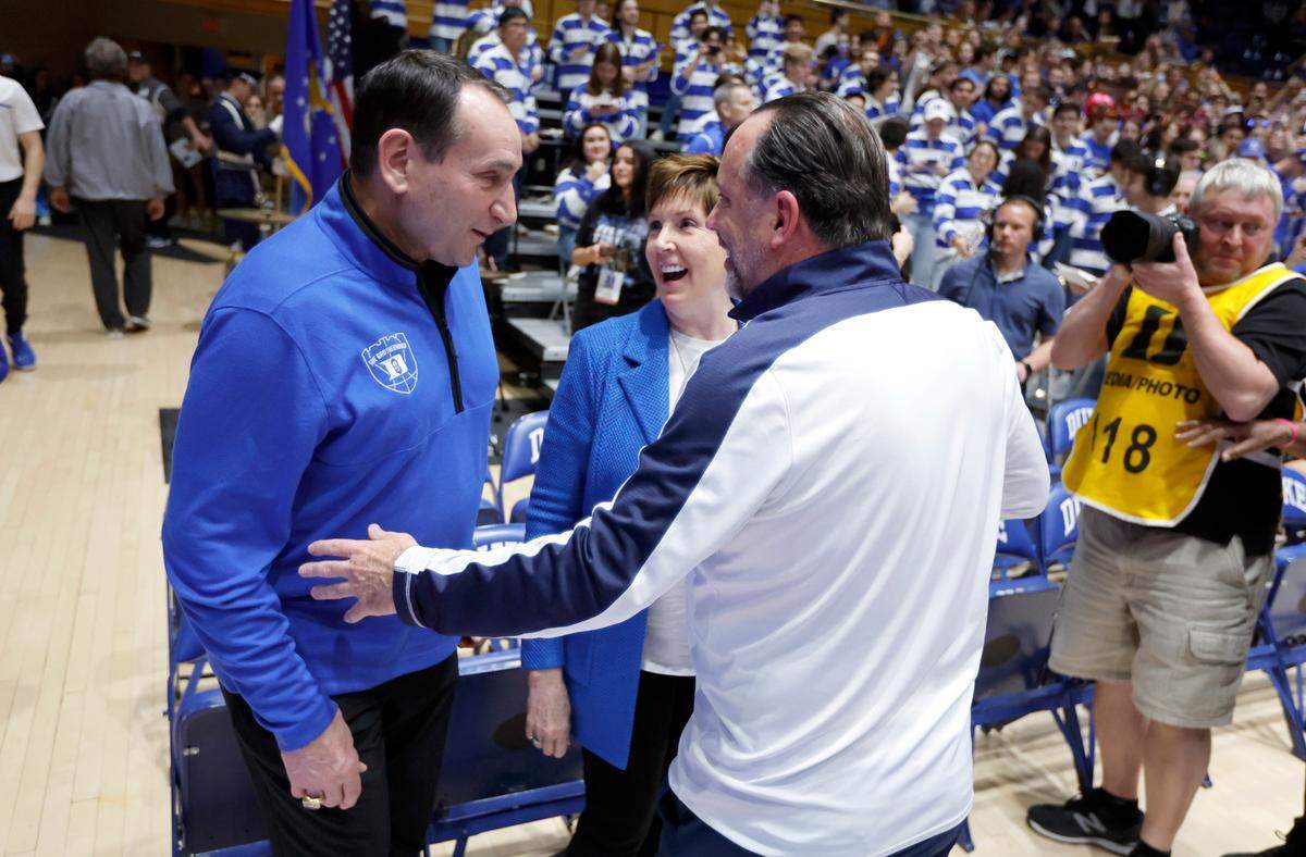 Former Duke head coach Mike Krzyzewski and his wife, Mickie, laugh with Notre Dame head coach Mike Brey before Duke’s game against Notre Dame at Cameron Indoor Stadium in Durham, N.C., Tuesday, Feb. 14, 2023.