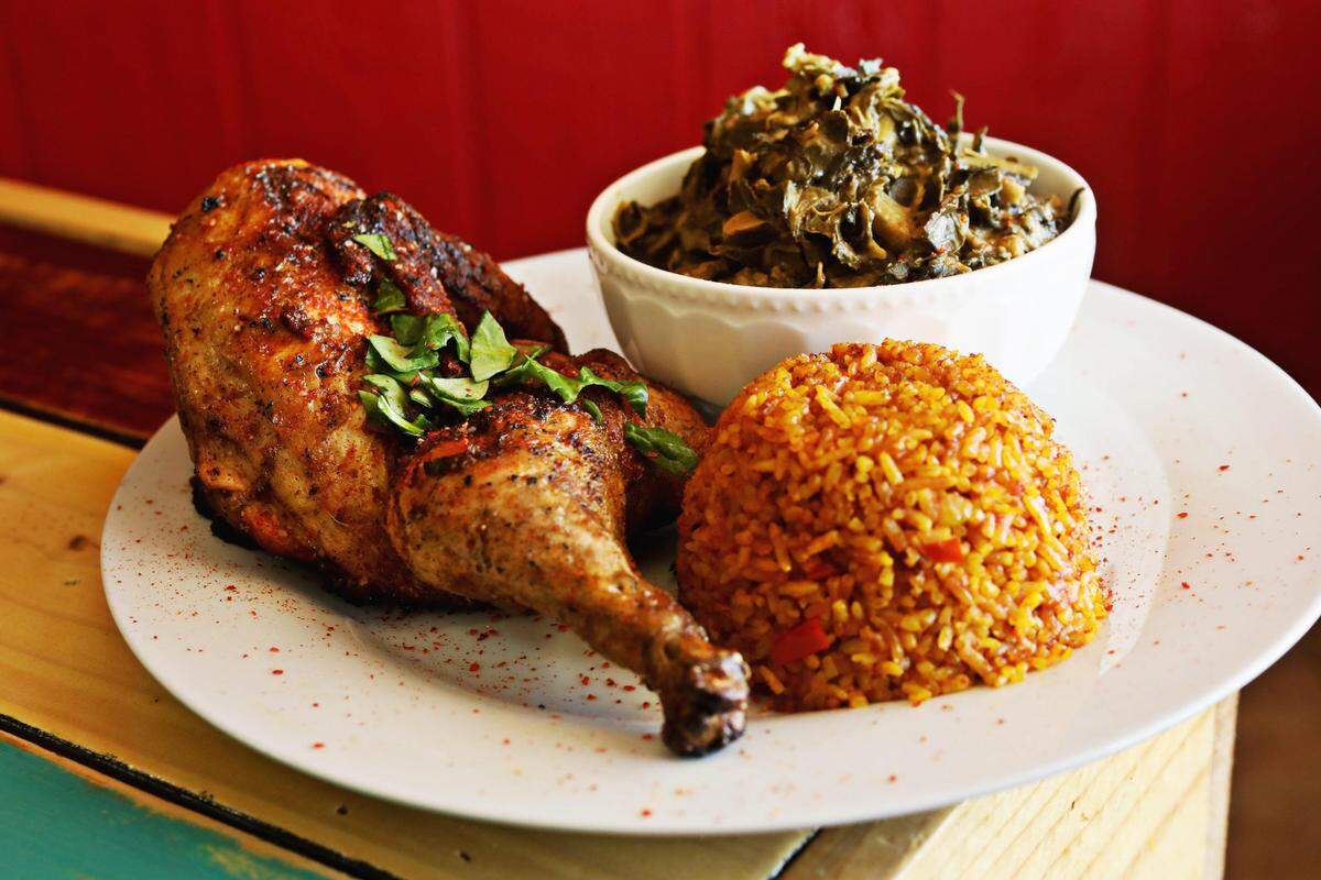 Zweli's in Durham serves a half chicken with a side of collard greens cooked with peanut butter and Jollof rice. 