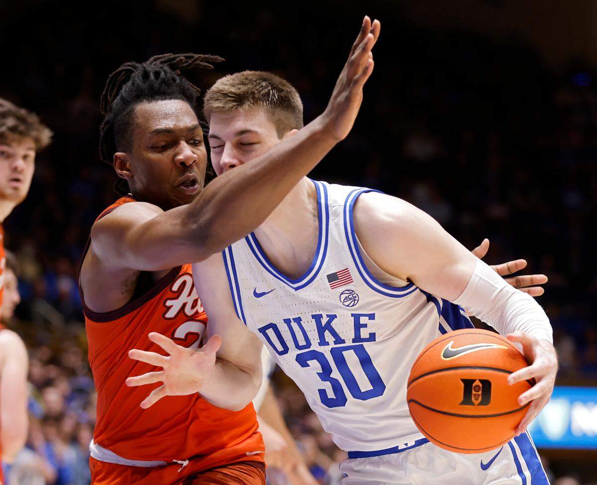 Duke’s Kyle Filipowski is fouled as he drives past Virginia Tech’s Justyn Mutts during the second half of the Blue Devils’ 81-65 win over Virginia Tech on Saturday, Feb. 25, 2023, at Cameron Indoor Stadium in Durham, N.C.
