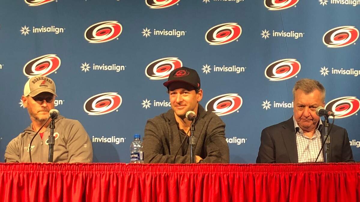 Justin Williams, center, discusses his return to the Carolina Hurricanes while flanked by general manager Don Waddell, right, and owner Tom Dundon, left, at PNC Arena on Wednesday.
