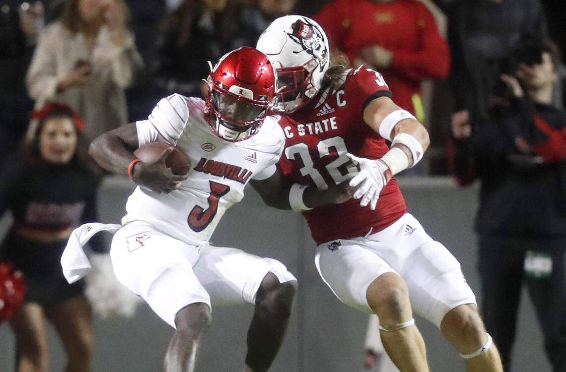 Louisville quarterback Malik Cunningham (3) is tackled by N.C. State linebacker Drake Thomas (32) during the first half of N.C. State’s game against Louisville at Carter-Finley Stadium in Raleigh, N.C., Saturday, October 30, 2021.