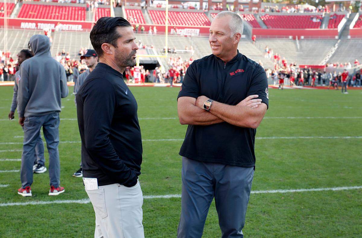 N.C. State head coach Dave Doeren talks with Duke head coach Manny Diaz before N.C. State’s game against Duke at Carter-Finley Stadium in Raleigh on Saturday, Nov. 9.