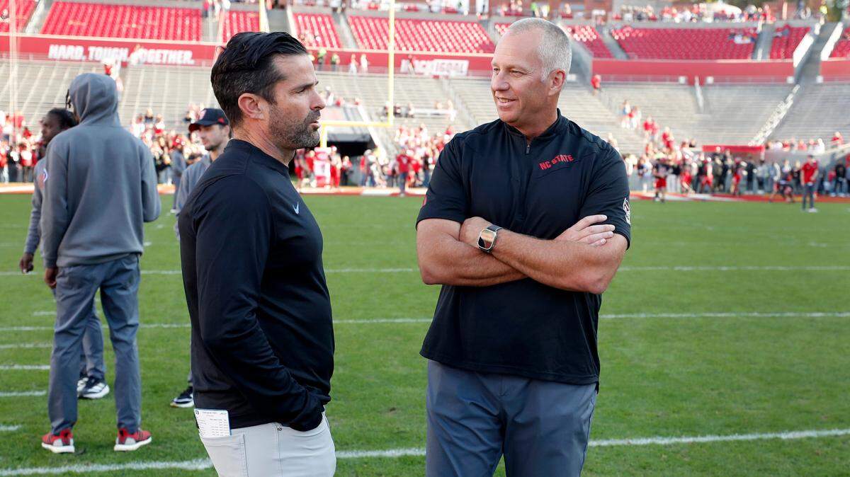 N.C. State head coach Dave Doeren talks with Duke head coach Manny Diaz before N.C. State’s game against Duke at Carter-Finley Stadium in Raleigh on Saturday, Nov. 9.