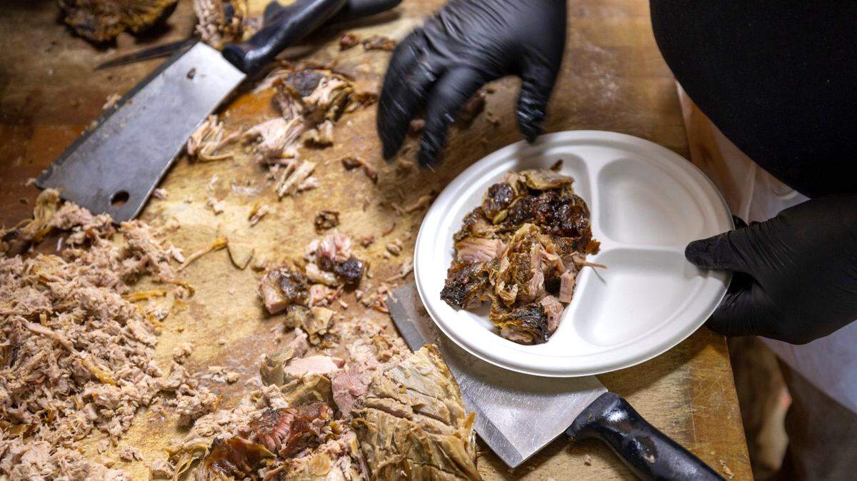 At Lexington Barbecue, a plate of coarse chopped barbecue is prepared in the kitchen on Tuesday, October 10, 2023 in Lexington, N.C.