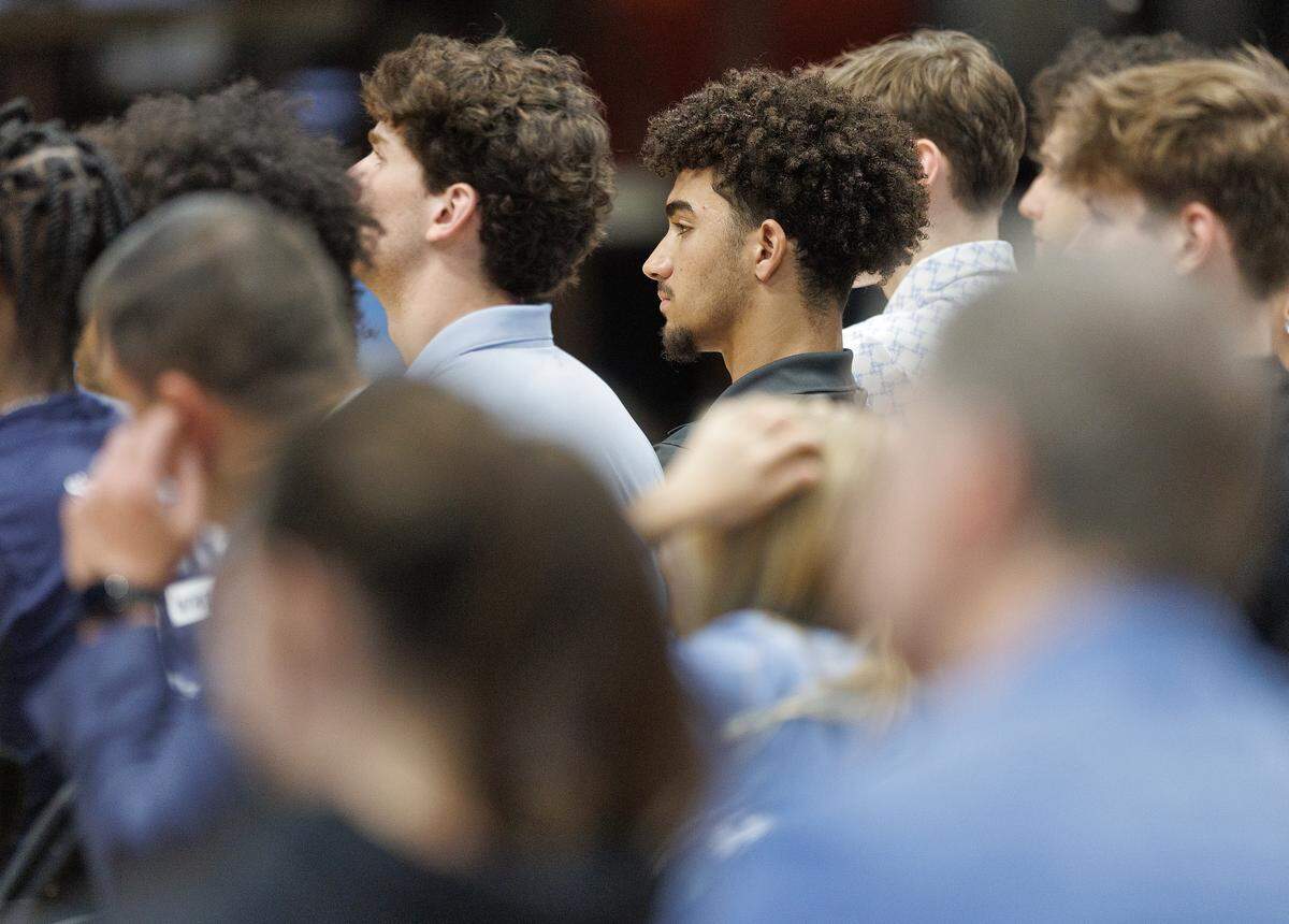 North Carolina freshman guard Derek Dixon listens as new men’s basketball head coach Michael Malone answers questions during a press conference at the Smith Center on Tuesday, April 7, 2026, in Chapel Hill, N.C.