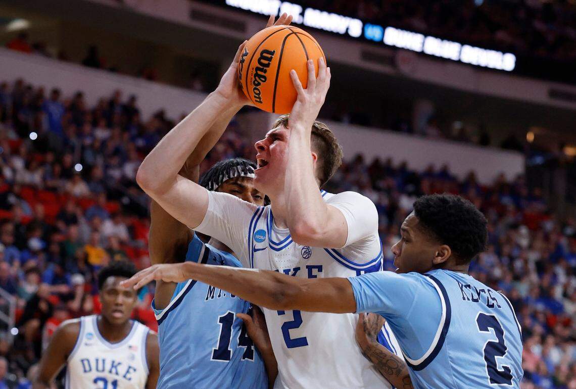 Duke’s Cooper Flagg (2) drives between Mount St. Mary’s Jedy Cordilia (14) and Arlandus Keyes (2) during the first half of Duke’s game against Mount St. Mary’s in the first round of the 2025 NCAA Men’s Basketball Tournament at the Lenovo Center in Raleigh, N.C., Friday, March 21, 2025.