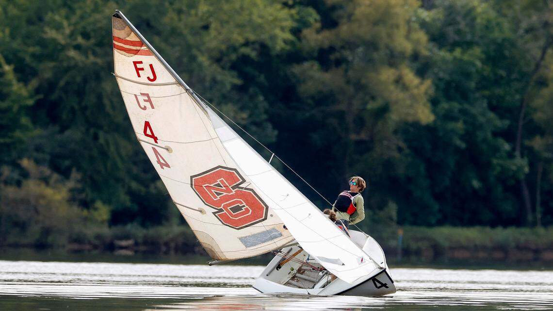 Ryan Brelage along with Evelyn Hannah practice roll tacking on a Flying Junior (FJ) dinghy during the N.C. State sailing team practice at Lake Crabtree in Morrisville, N.C., Friday, Sept. 6, 2024.