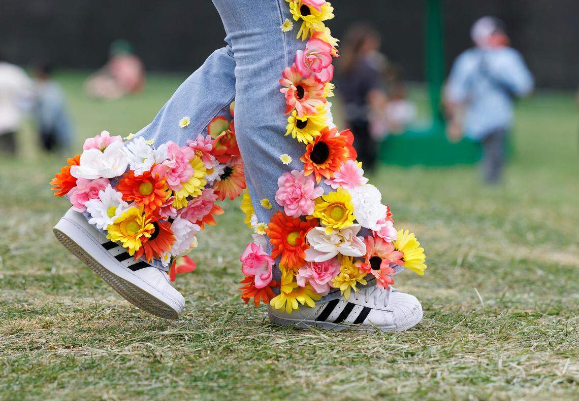 A person wears flower-adorned blue jeans during the fifth Dreamville Festival on Sunday, April 6, 2025, at Dorothea Dix Park in Raleigh, N.C.