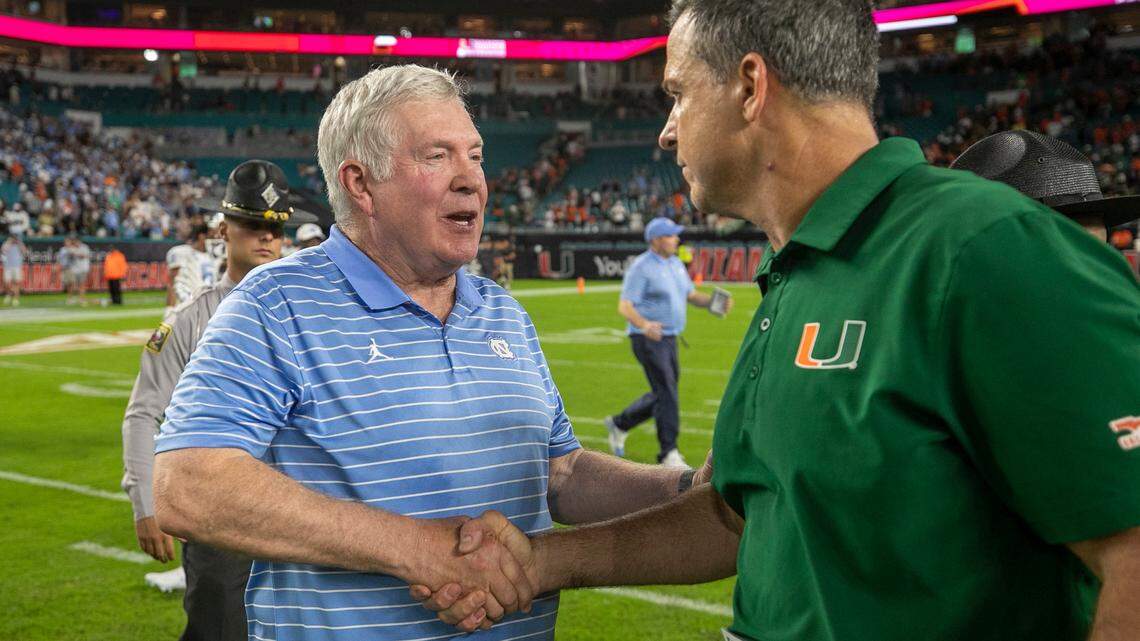 Miami coach Mario Cristobal congratulates North Carolina coach Mack Brown following the Tar Heels’ 27-24 victory on Saturday, October 8, 2022 at Hard Rock Stadium in Miami Gardens, Florida.