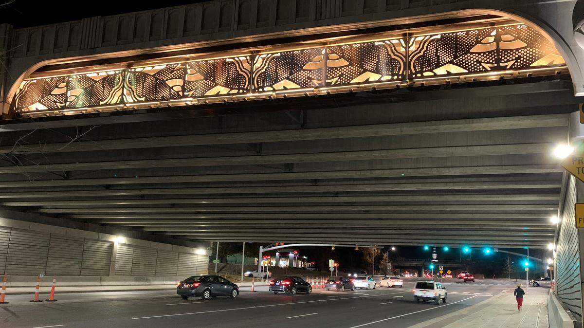Illuminated artwork on the west side of the Capital Boulevard bridge over Peace Street in downtown Raleigh. After a lengthy delay, the art will be in place on the Peace and Wade Avenue bridges by the end of the year, according to the N.C. Department of Transportation.