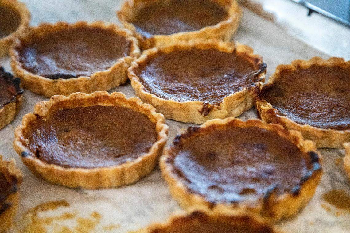 Persimmon tarts sit on a tray during the opening of Longleaf Swine in Raleigh Friday, Nov. 4, 2022.