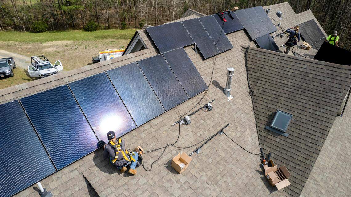 Yes Solar Solutions workers install solar panels on a residential home in Wake Forest Wednesday, March 30, 2022.