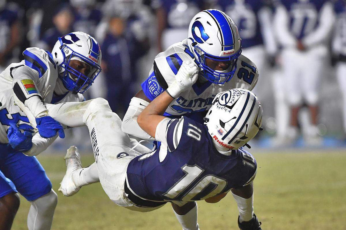 Grimsley running back Hudson Cooper (10) gets the first down against Clayton defensive back Daniel Lovelace-Davis (21) during the second half.  The Clayton Comets and the Grimsley Whirlies met in the NCHSAA 7A football Championships in Chapel Hill, NC on December 12, 2025.