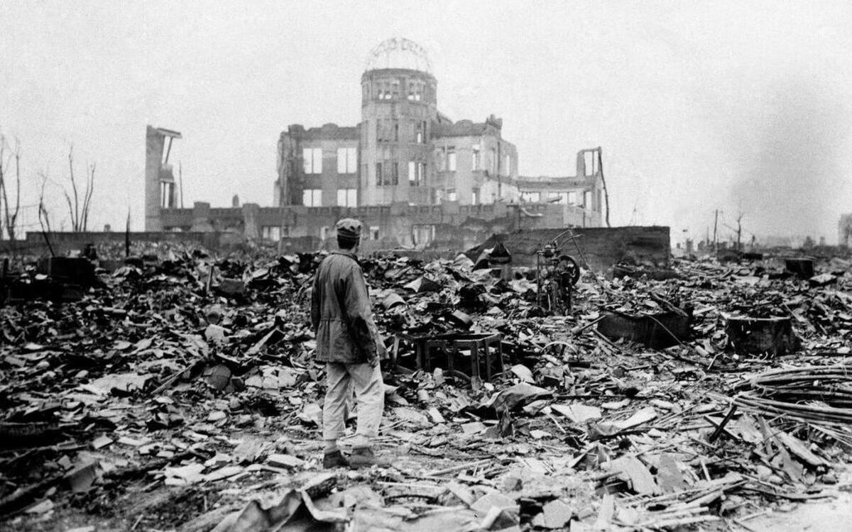 
This photo from Sept. 8, 1945, shows an Allied correspondent standing in the rubble in front of what was a theater in Hiroshima, Japan. 
