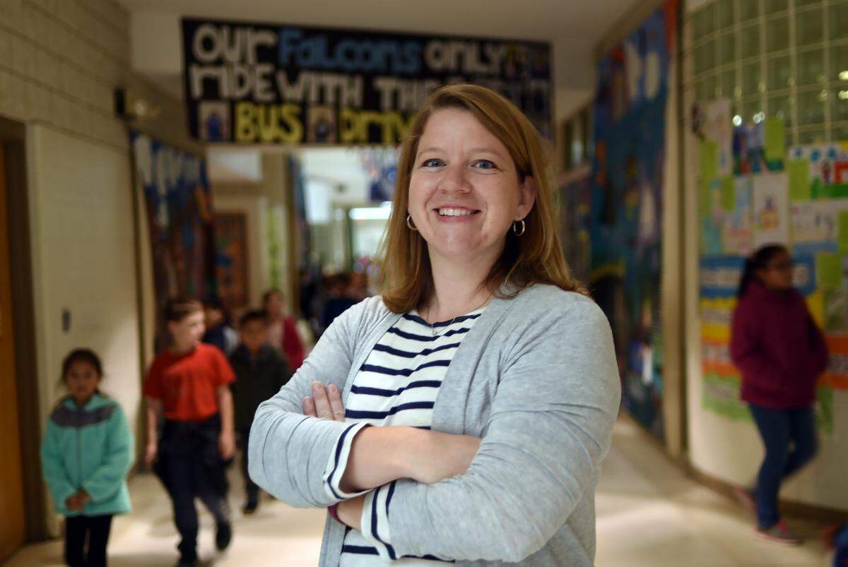 Annie Harrison, who recently bought a new home in Durham, motivated in part by rising prices and interest rates. She is pictured here in a hallway at Forest View Elementary in Durham, N.C. Friday, Nov. 16, 2018.