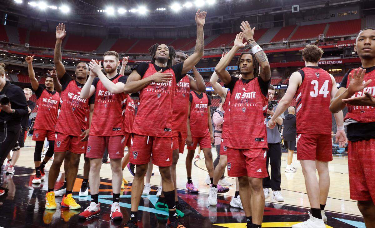 Wolfpack players thank the fans after N.C. State’s practice at State Farm Stadium in Glendale, Ariz., Friday, April 5, 2024. The Wolfpack will face Purdue in the NCAA Tournament national semifinals Saturday.